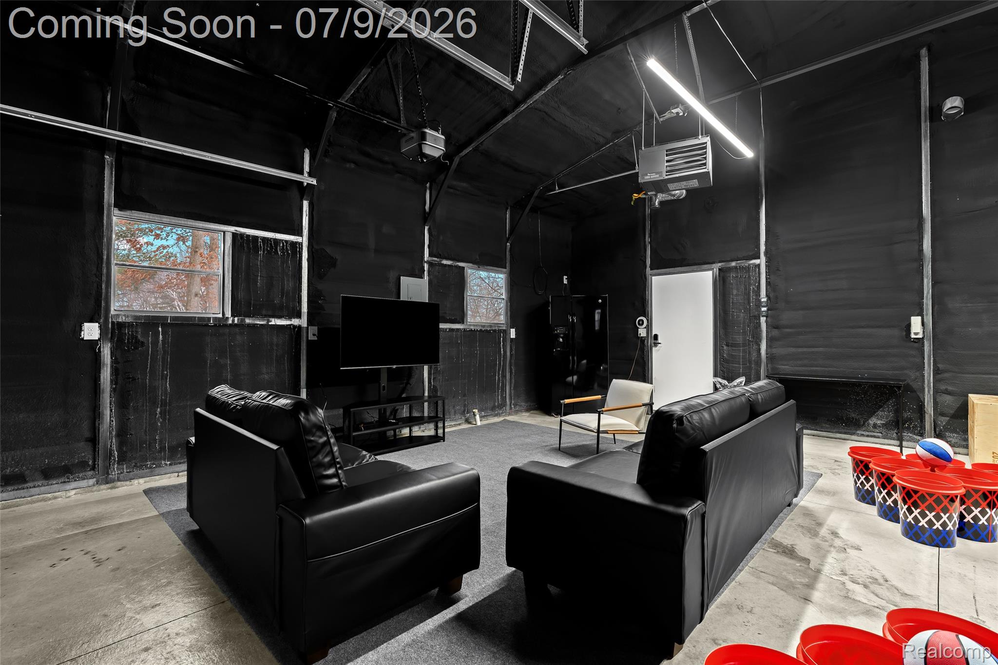2566 Harrington Road Rochester, MI 48307 - Photo 58 of 64 Fun hangout space in the garage with a thermostat controlled heating unit, refrigerator, TV and games