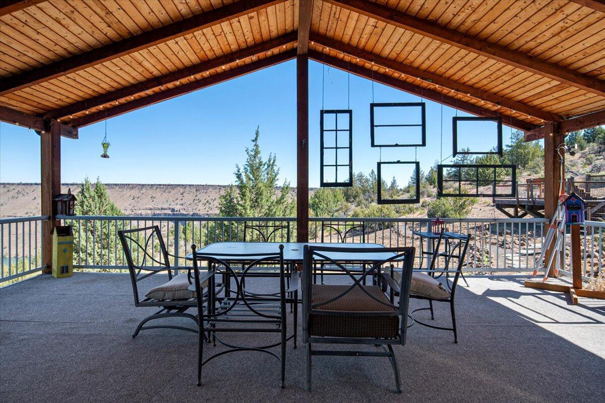 11182 Southwest Dynamite Lane Culver, OR 97734 - Photo 18 of 70 a view of a patio with table and chairs with wooden floor and fence