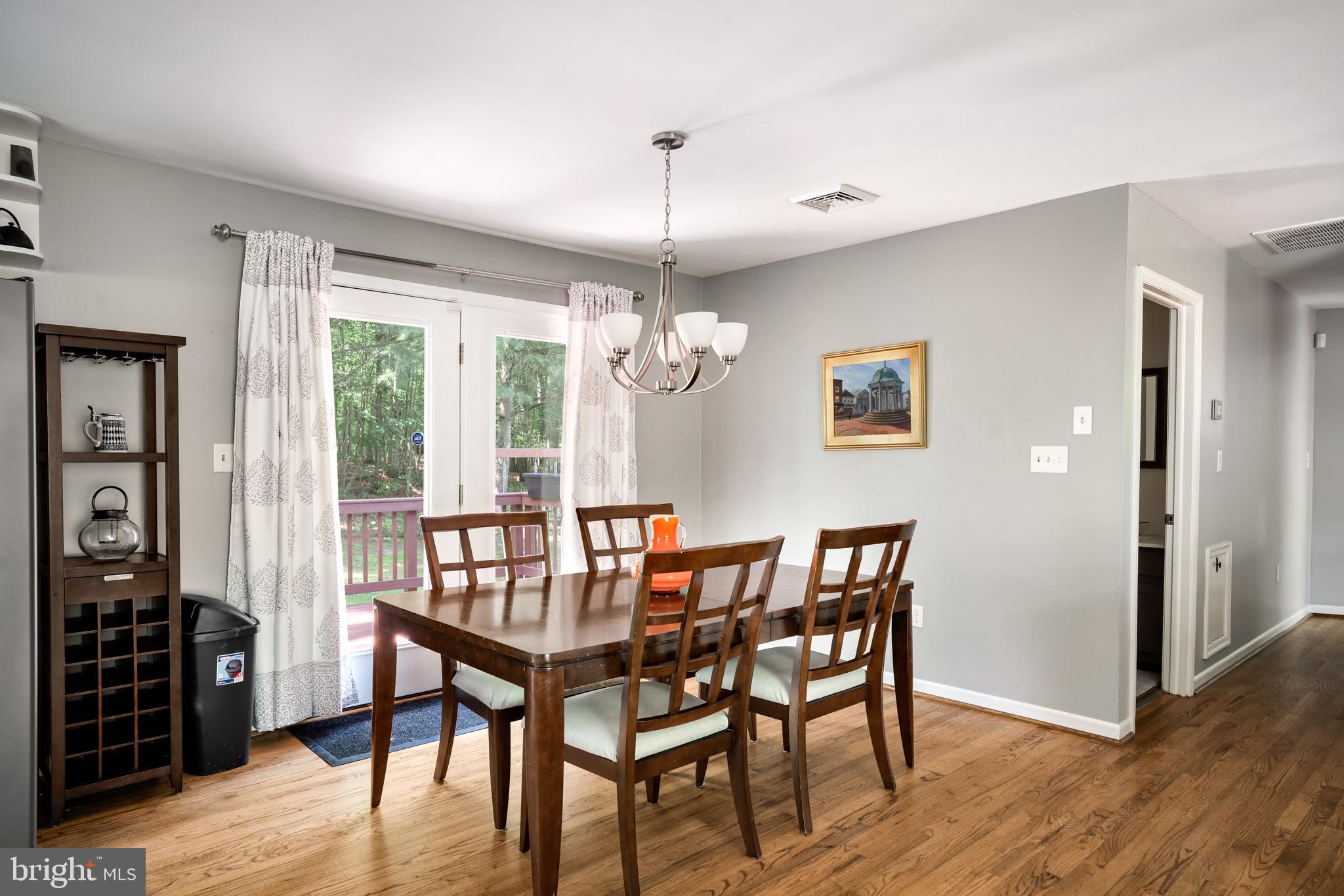 Dining area with doors leading to back deck