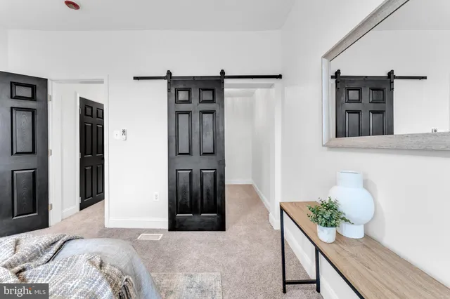 a bedroom with furniture and a window