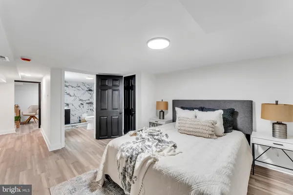 a bedroom with a bed and a large mirror