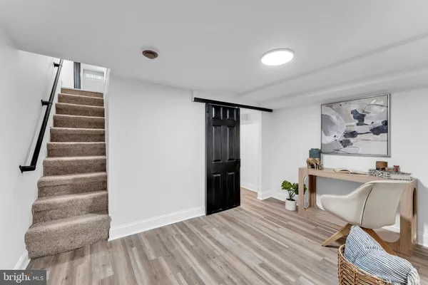 a view of a livingroom with furniture and staircase