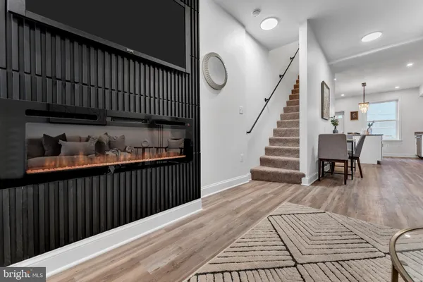 a view of a hallway with wooden floor and stairs