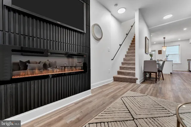 a view of a hallway with wooden floor and stairs
