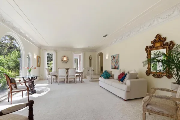 a bedroom with furniture and a large window