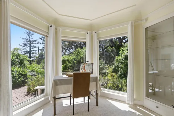 a view of a patio with table and chairs under an umbrella
