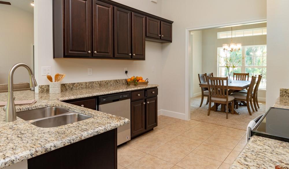 551 Quarry Lane Sebastian, FL 32958 - Photo 15 of 23 a kitchen with stainless steel appliances granite countertop a sink a stove and island