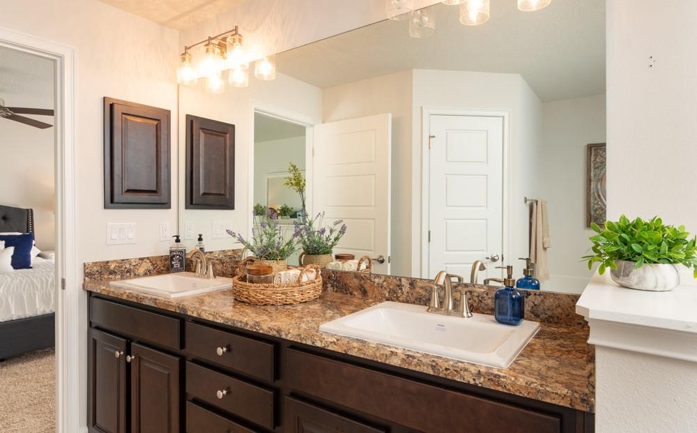 551 Quarry Lane Sebastian, FL 32958 - Photo 19 of 23 a bathroom with a granite countertop double vanity sink and a mirror