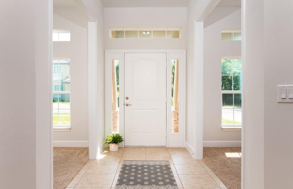 551 Quarry Lane Sebastian, FL 32958 - Photo 2 of 23 a view of a hallway with wooden floor and a dining room