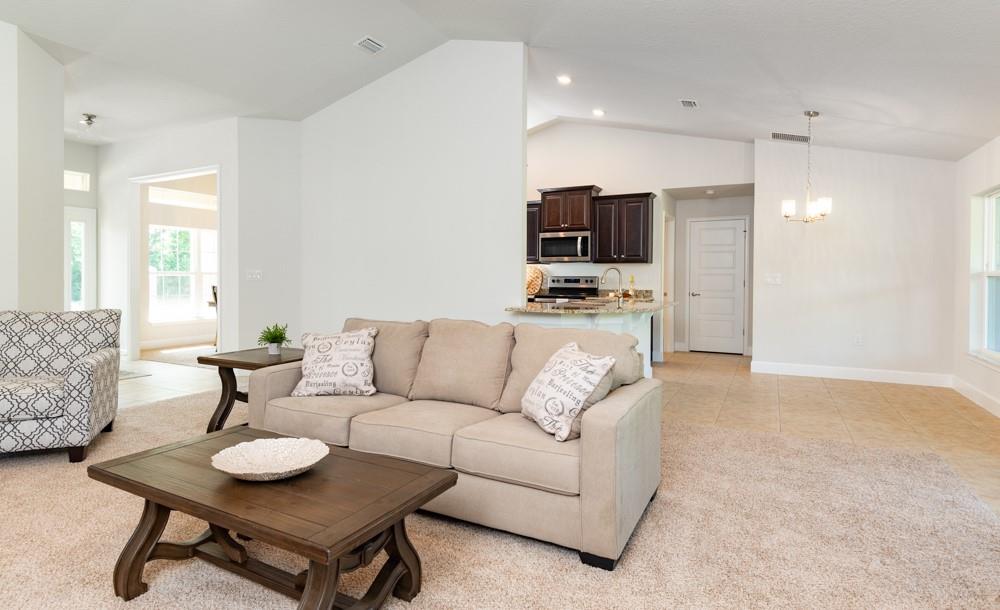 551 Quarry Lane Sebastian, FL 32958 - Photo 8 of 23 a living room with furniture and a flat screen tv