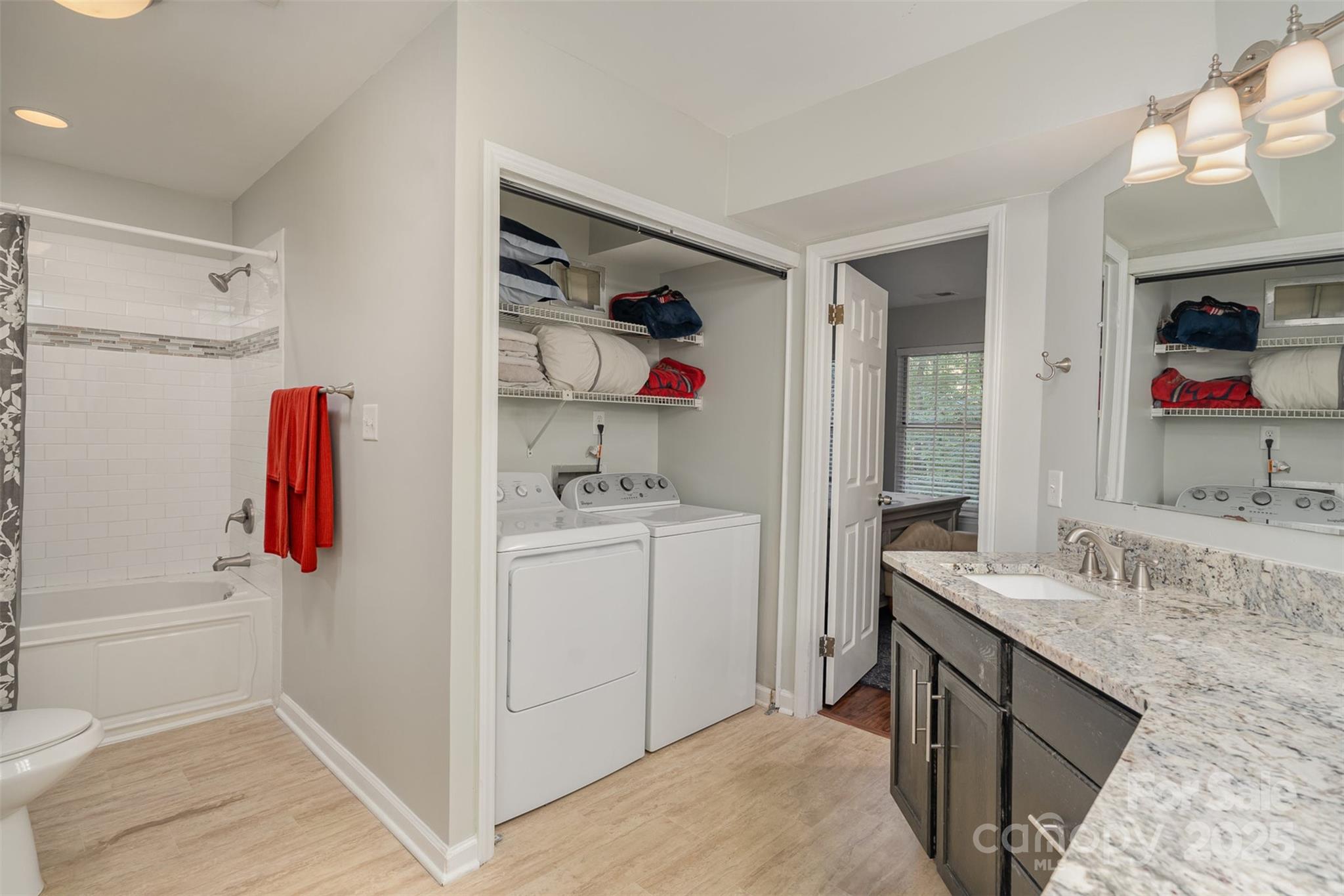 6501 Clavell Lane, Unit B Charlotte, NC 28210 - Photo 12 of 13 a bathroom with a sink vanity and tub