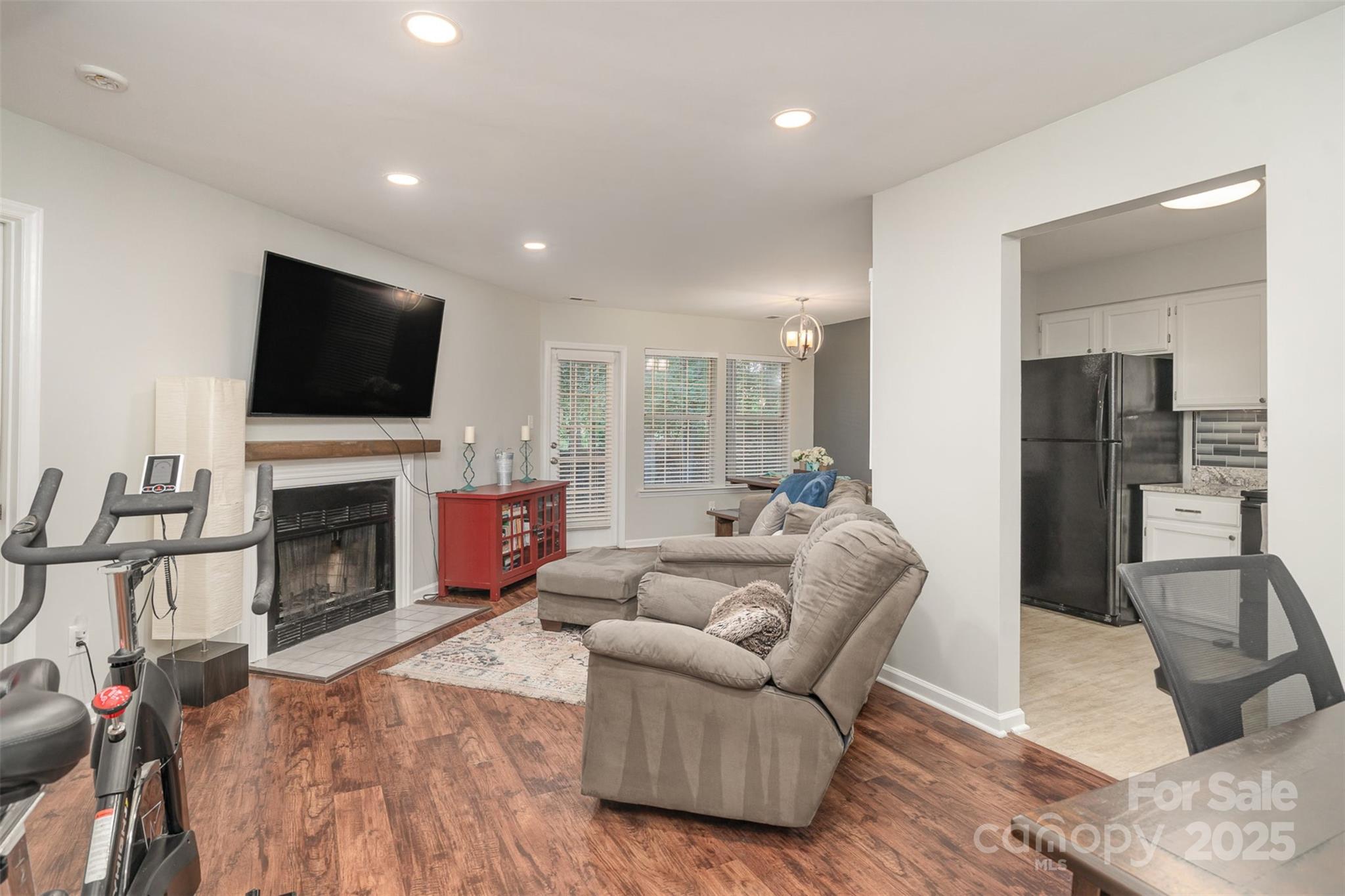 6501 Clavell Lane, Unit B Charlotte, NC 28210 - Photo 6 of 13 a living room with furniture a fireplace and a flat screen tv