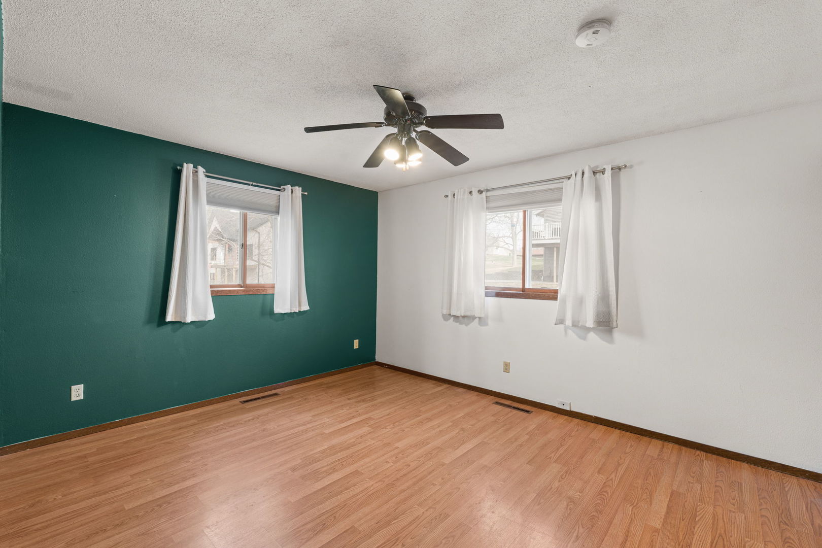 214 South 3rd Street Le Claire, IA 52753 - Photo 15 of 40 wooden floor in an empty room with a window