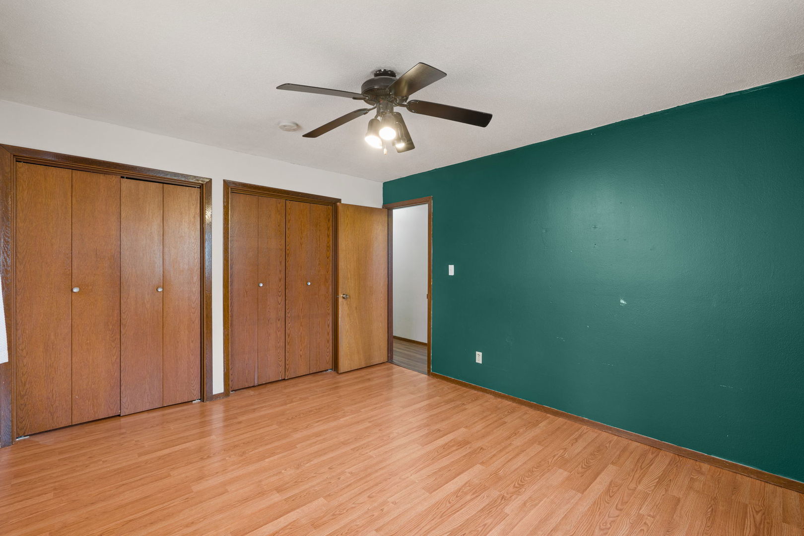 214 South 3rd Street Le Claire, IA 52753 - Photo 16 of 40 a view of empty room with wooden floor and fan