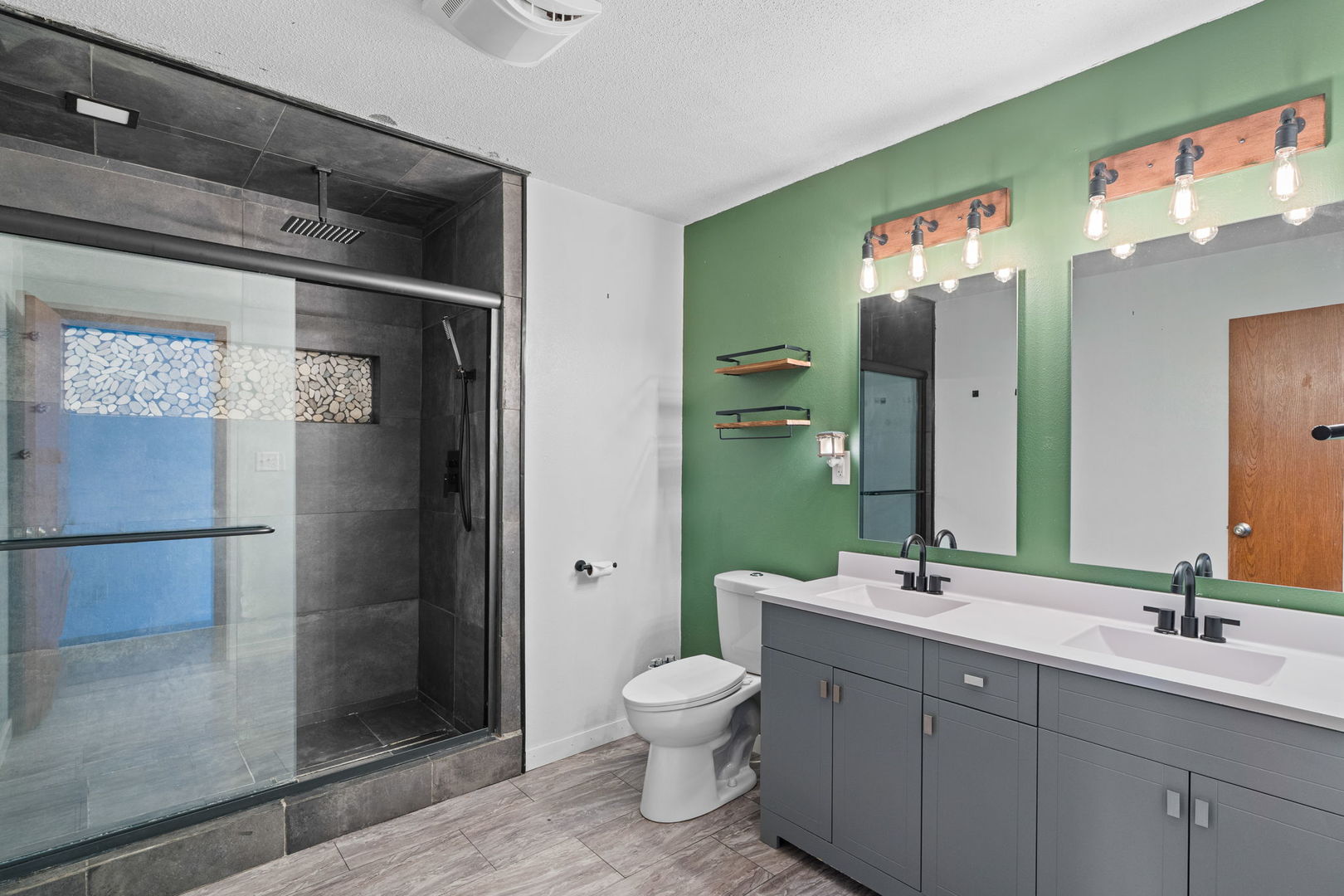 214 South 3rd Street Le Claire, IA 52753 - Photo 17 of 40 a bathroom with a toilet a sink and mirror