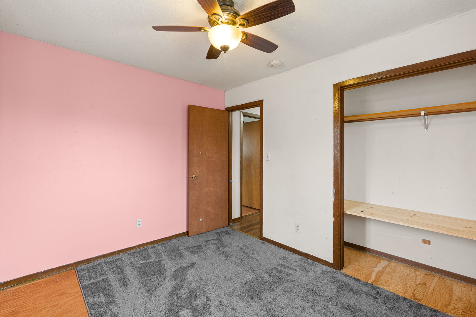214 South 3rd Street Le Claire, IA 52753 - Photo 21 of 40 a view of a room with closet and a ceiling fan