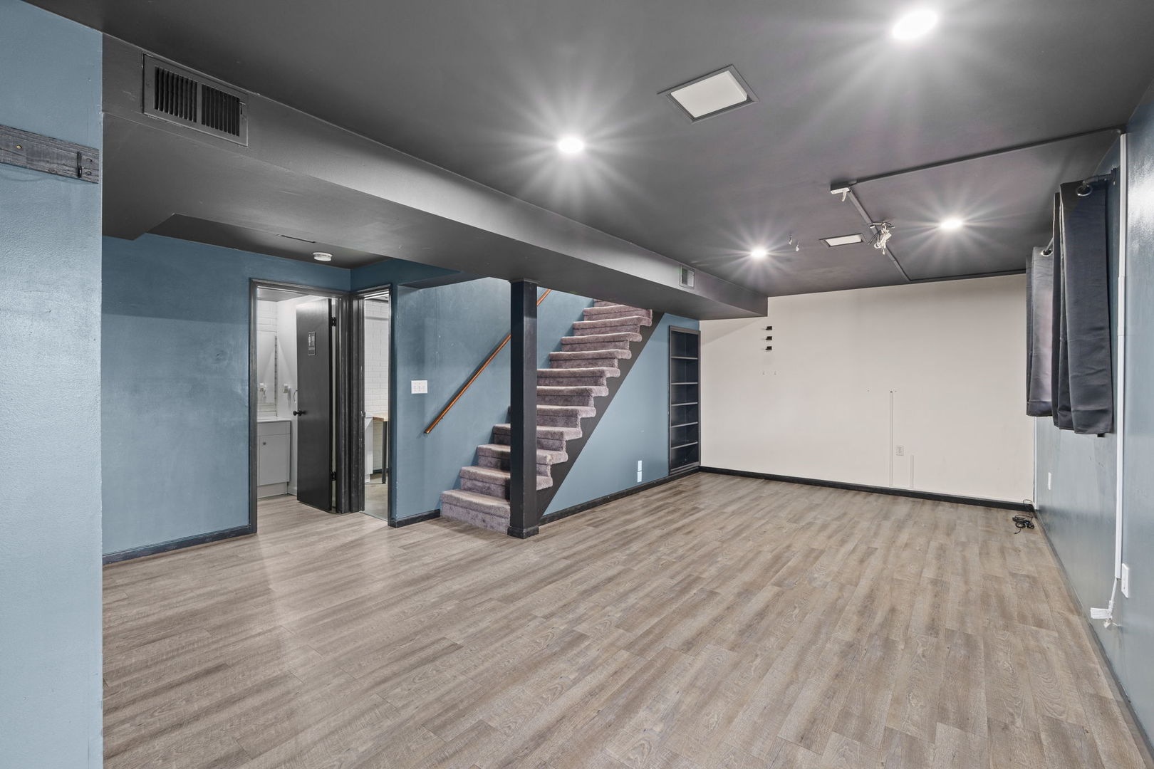 214 South 3rd Street Le Claire, IA 52753 - Photo 23 of 40 a view of an empty room with wooden floor and stairs