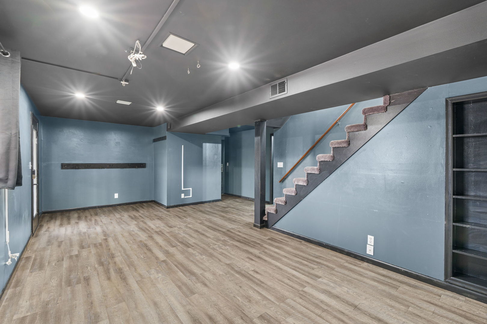 214 South 3rd Street Le Claire, IA 52753 - Photo 24 of 40 a view of an empty room with wooden floor and stairs