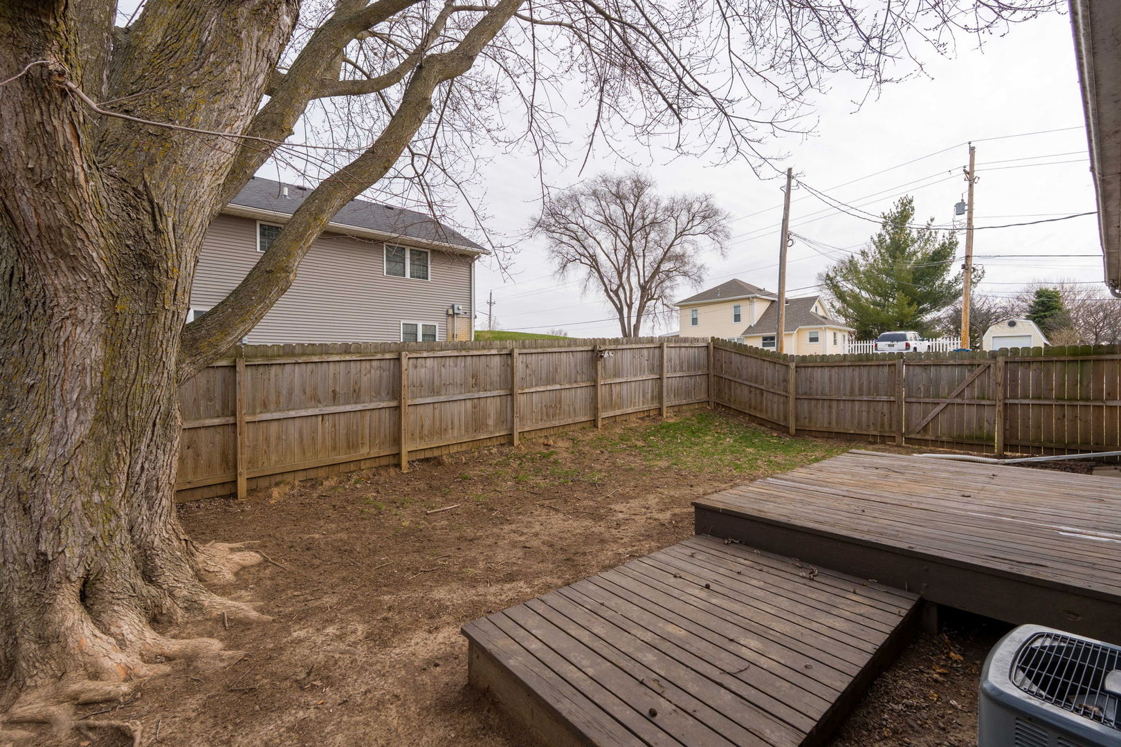 214 South 3rd Street Le Claire, IA 52753 - Photo 30 of 40 a view of a wooden floor with a bench in the backyard