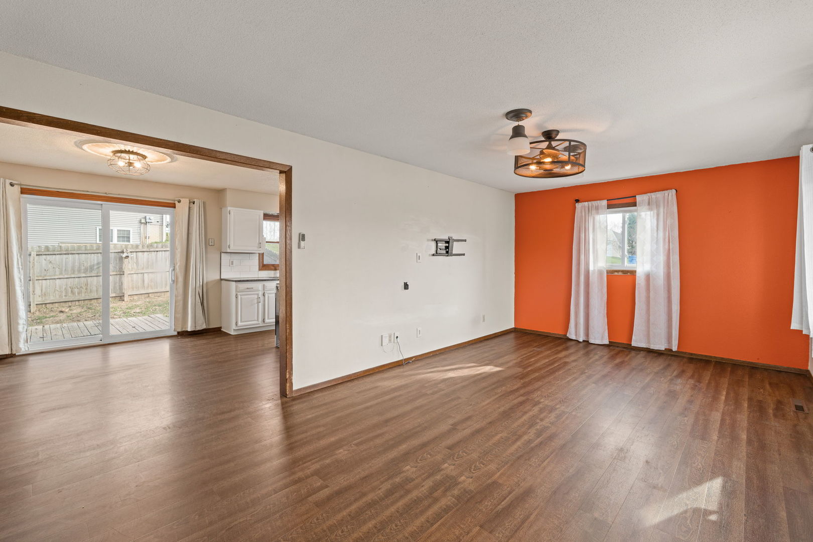 214 South 3rd Street Le Claire, IA 52753 - Photo 5 of 40 a view of an empty room with window and wooden floor
