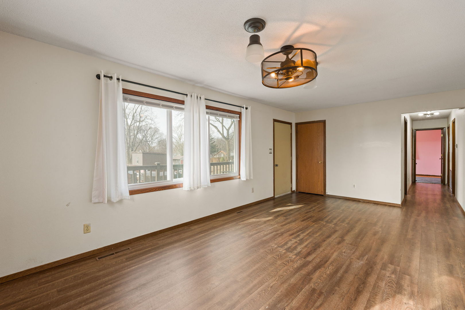 214 South 3rd Street Le Claire, IA 52753 - Photo 6 of 40 a view of an empty room with a window and wooden floor