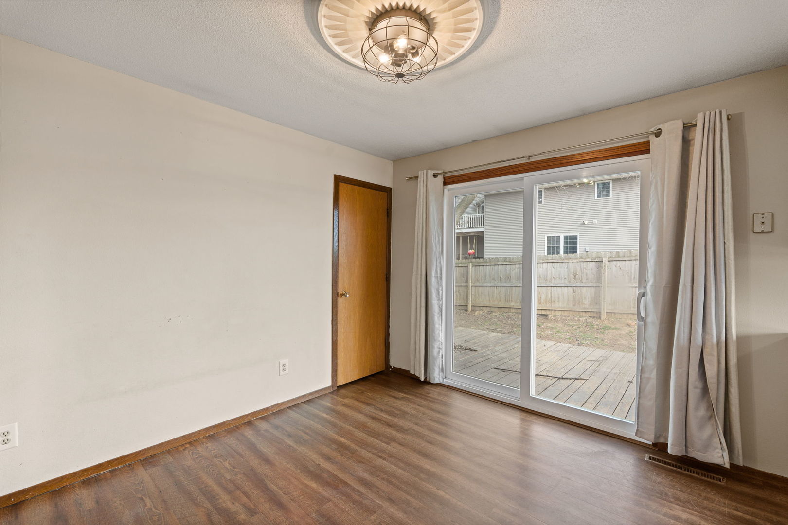 214 South 3rd Street Le Claire, IA 52753 - Photo 8 of 40 a view of an empty room with wooden floor and a window
