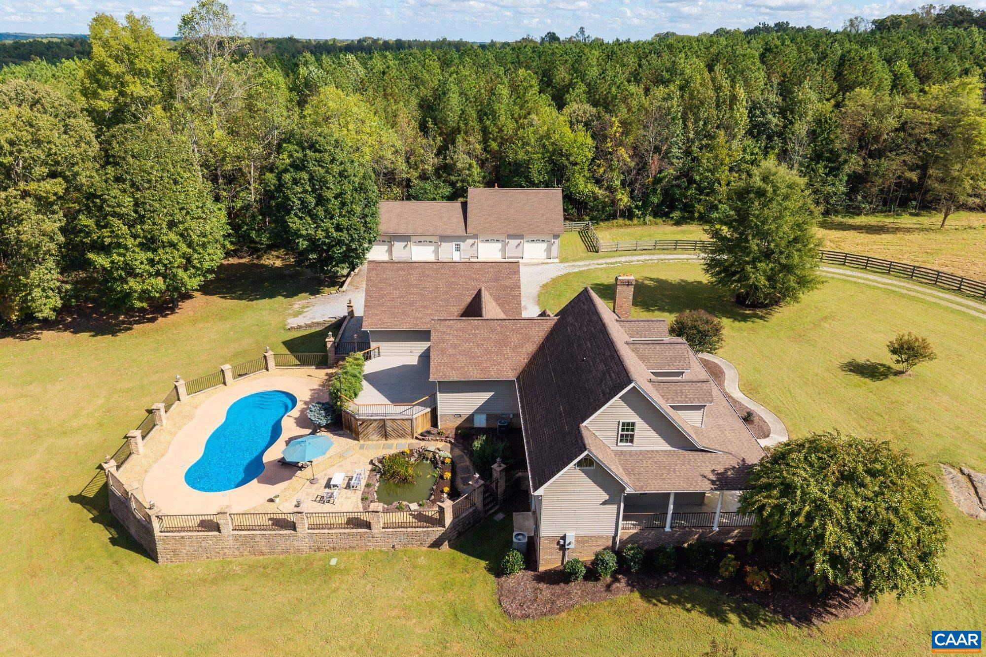884 Pleasant Gap Drive Dry Fork, VA 24549 - Photo 2 of 72 a aerial view of a house with swimming pool and large trees