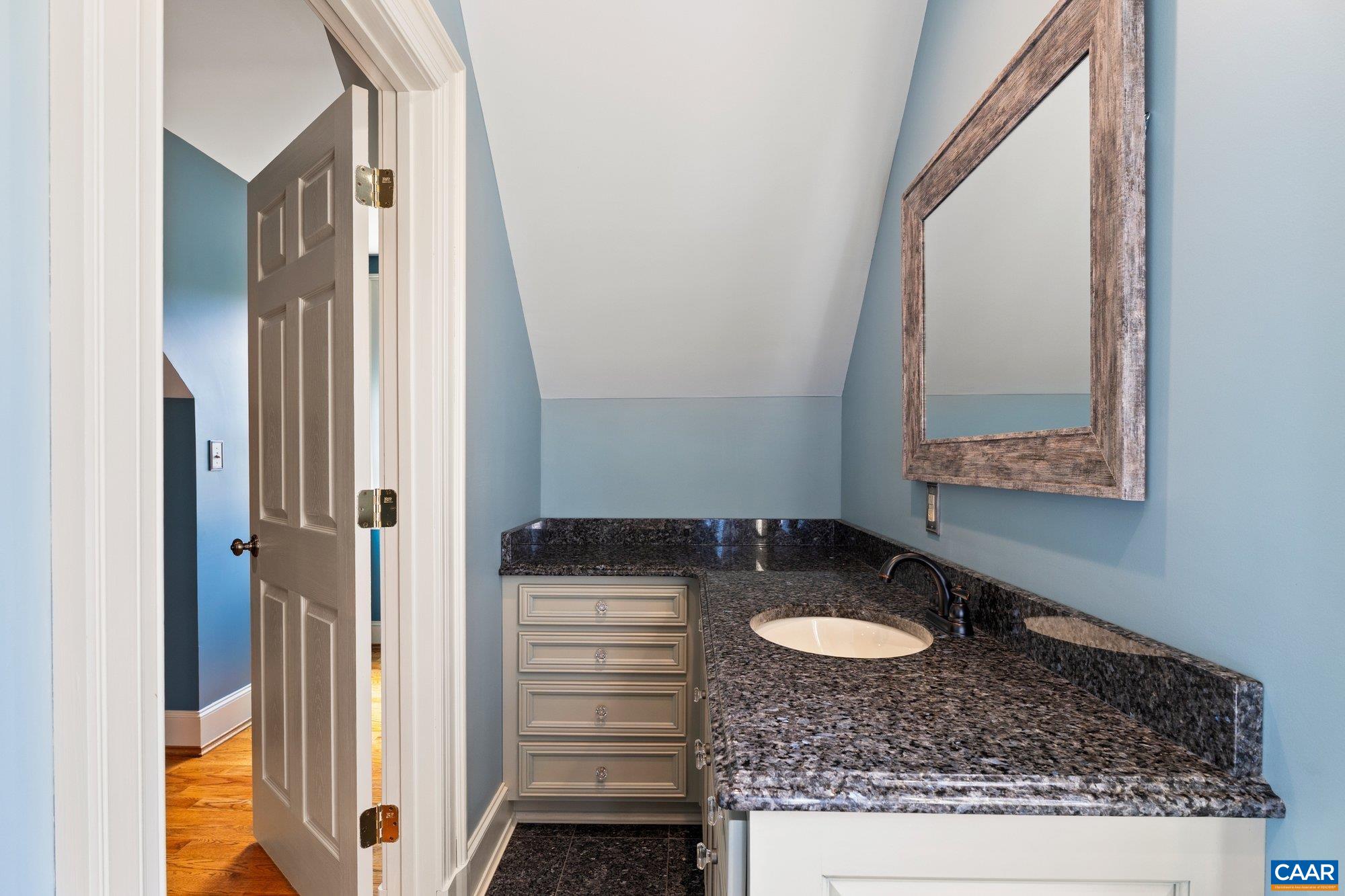 884 Pleasant Gap Drive Dry Fork, VA 24549 - Photo 40 of 72 a bathroom with a granite countertop sink and a mirror