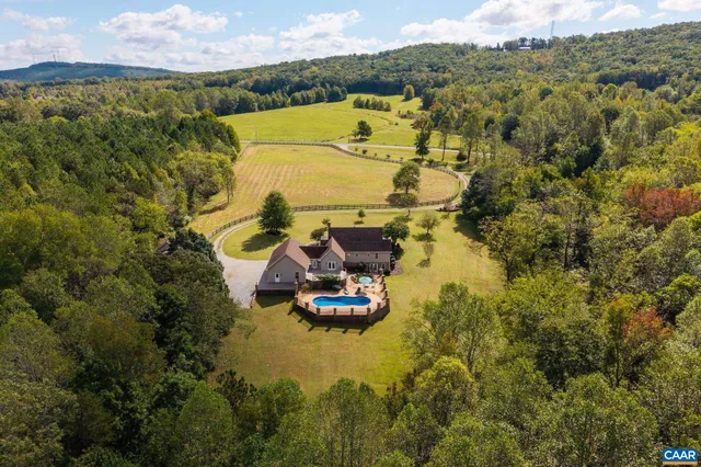 a view of empty room with stairs and wooden floor