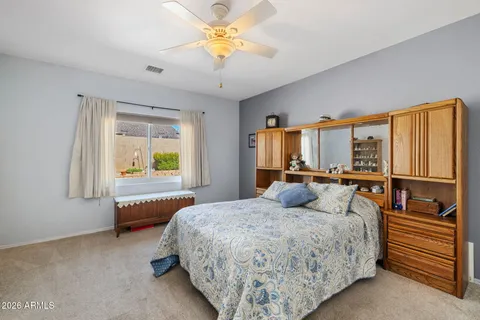 a bedroom with a large bed and a window