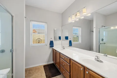 a spacious bathroom with a double vanity sink and a mirror