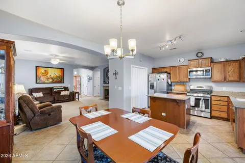 a living room with furniture a chandelier and a flat screen tv
