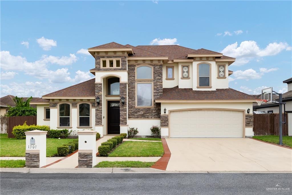 a front view of a house with a yard and garage
