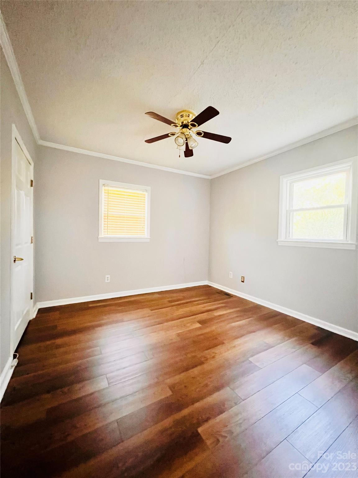 207 7th Avenue Southwest Conover, NC 28613 - Photo 6 of 12 a view of empty room with wooden floor and fan