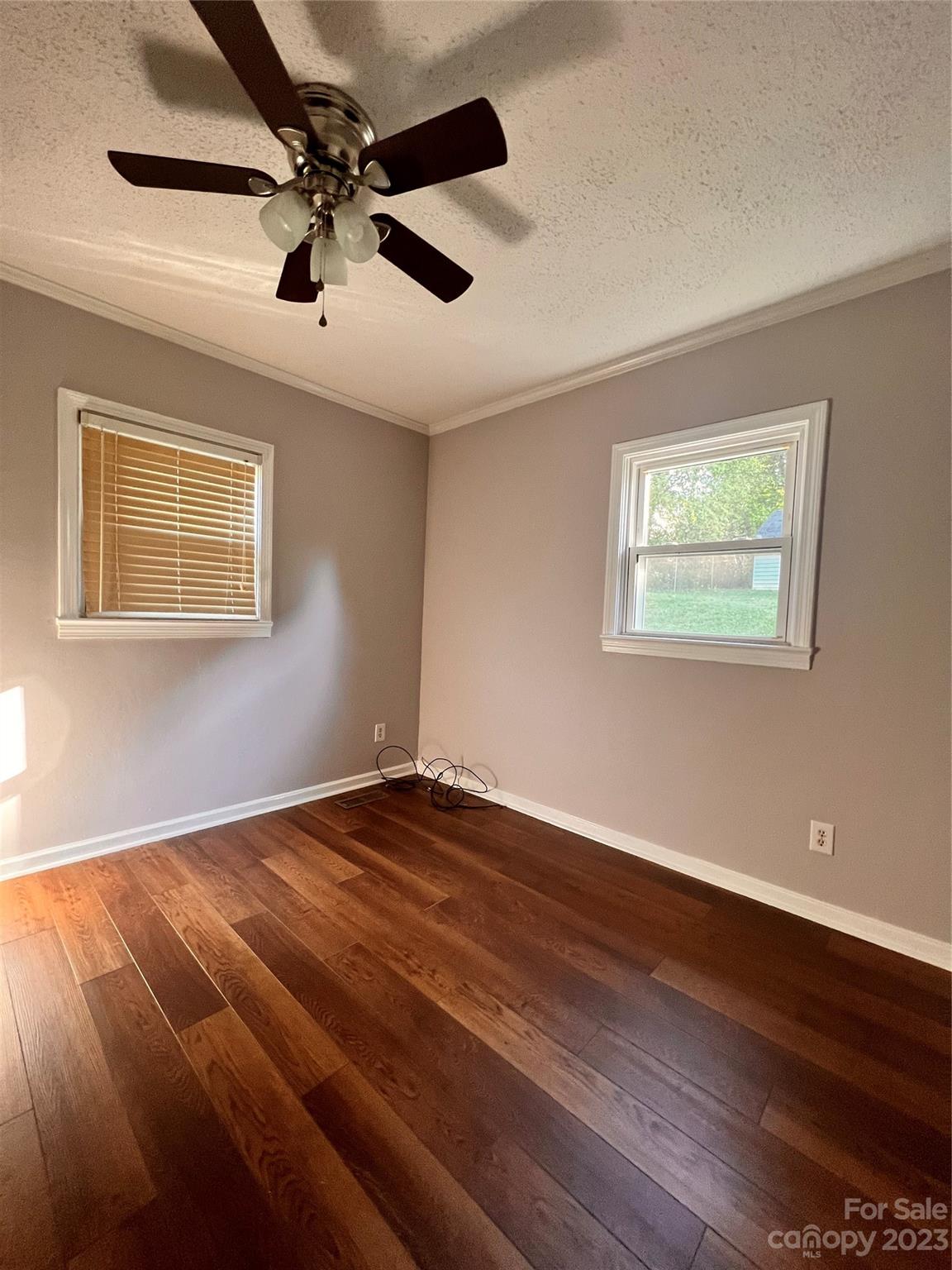 207 7th Avenue Southwest Conover, NC 28613 - Photo 9 of 12 a view of an empty room with wooden floor and a window