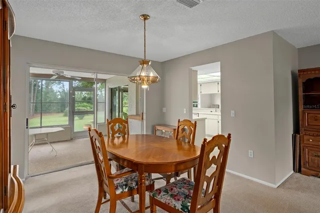 a room with furniture a dining table and chairs