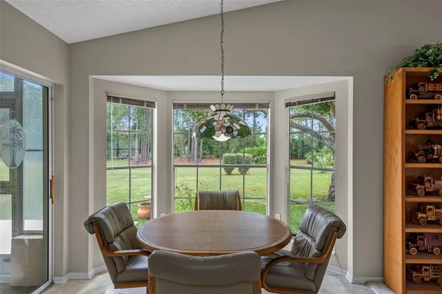 a bedroom with a bed a dresser and painting on the wall