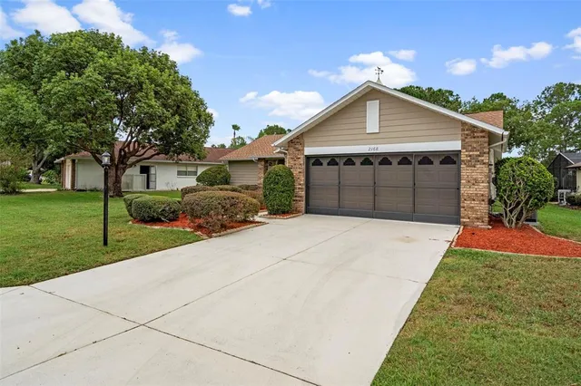 a front view of a house with a yard and garage