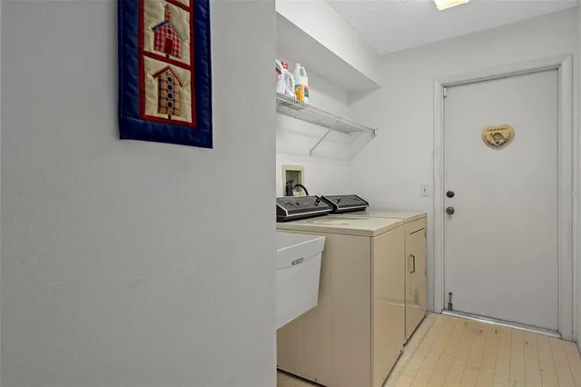 a view of a chair and tables in the patio next to a yard