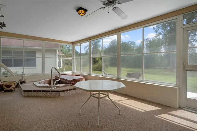 a front view of a house with a yard and potted plants