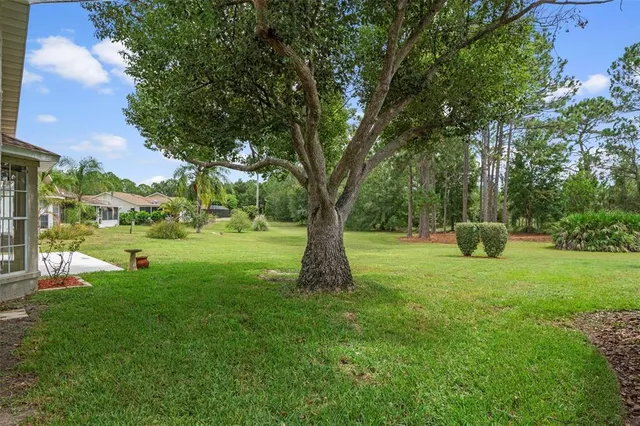 a view of a house with a big yard and potted plants
