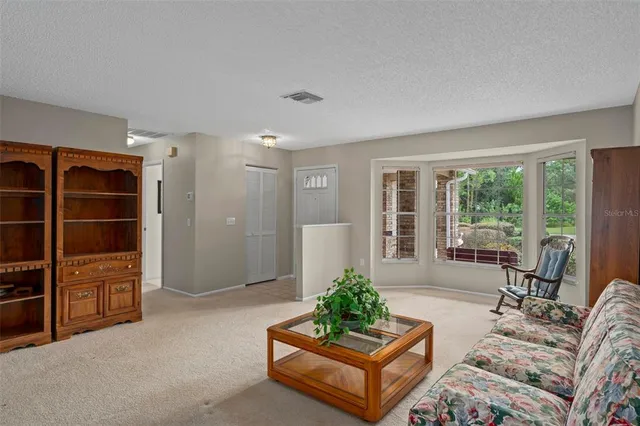 a dining room with furniture a chandelier and wooden floor