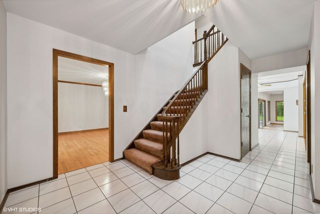 a view of entryway and hall with a door