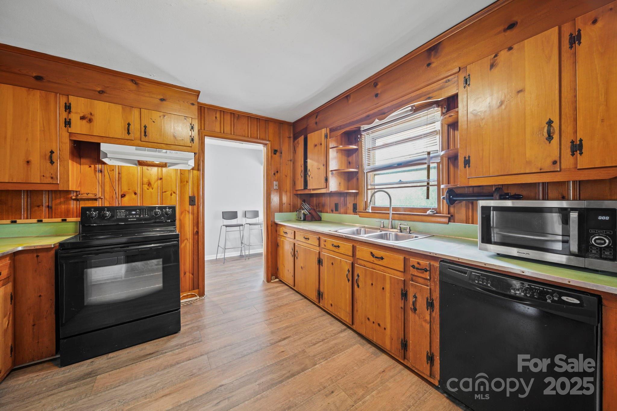 1703 East Perry Street Gastonia, NC 28054 - Photo 15 of 30 a kitchen with stainless steel appliances a stove a sink and a microwave