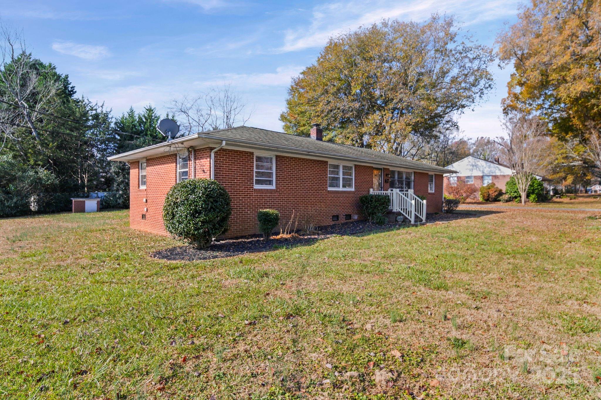 1703 East Perry Street Gastonia, NC 28054 - Photo 22 of 30 a front view of a house with a yard