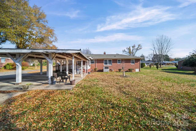 a view of a house with backyard porch and sitting area