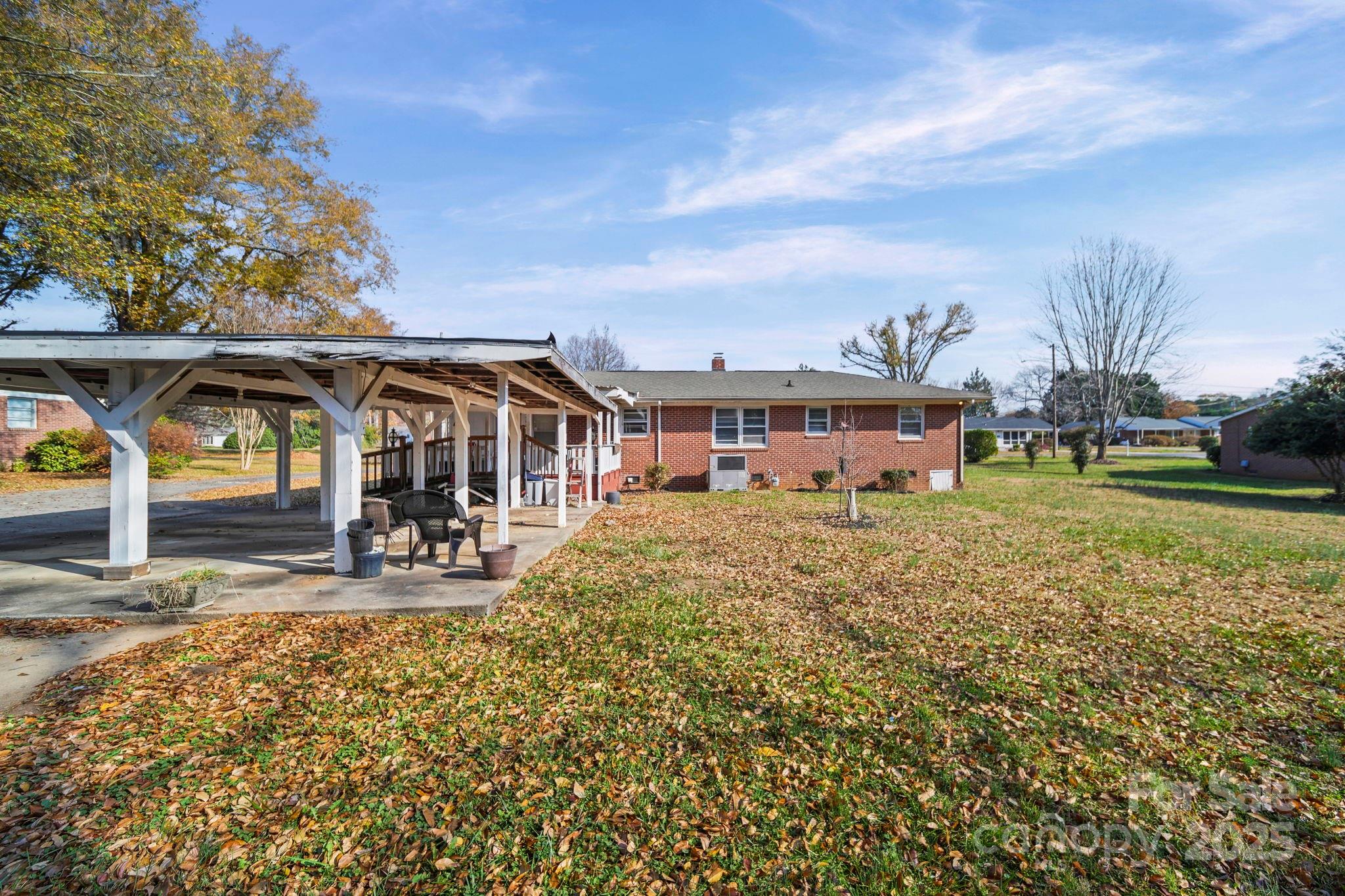 1703 East Perry Street Gastonia, NC 28054 - Photo 26 of 30 a view of a house with backyard porch and sitting area
