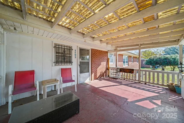 a balcony with furniture and a potted plant