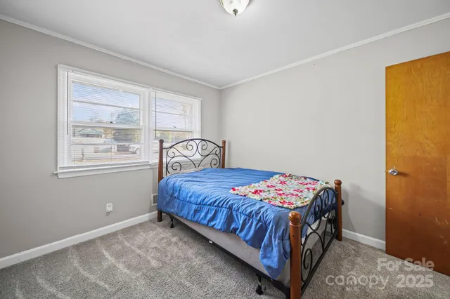 a bedroom with a bed and window