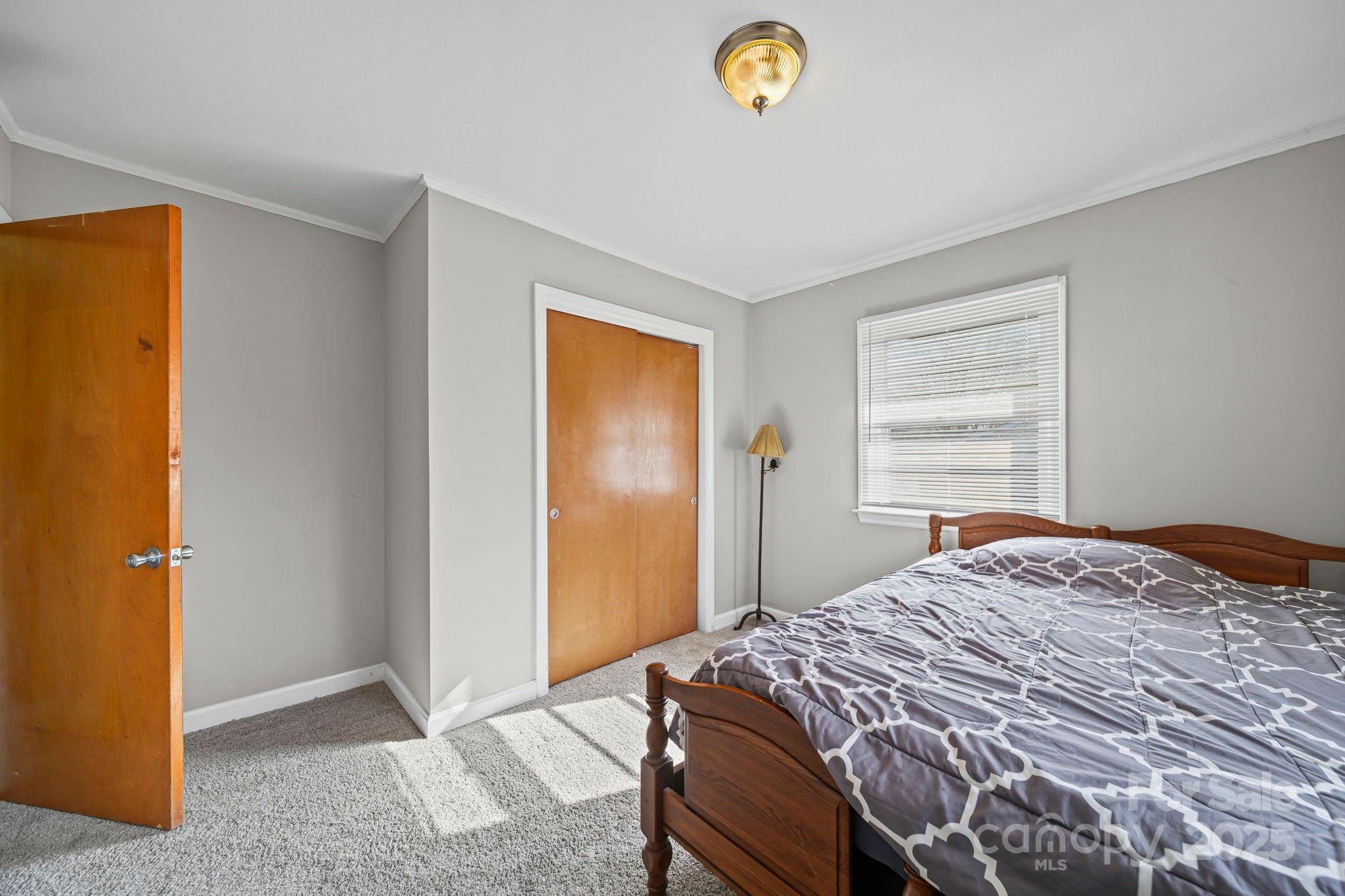 1703 East Perry Street Gastonia, NC 28054 - Photo 9 of 30 a bedroom with a bed and a window